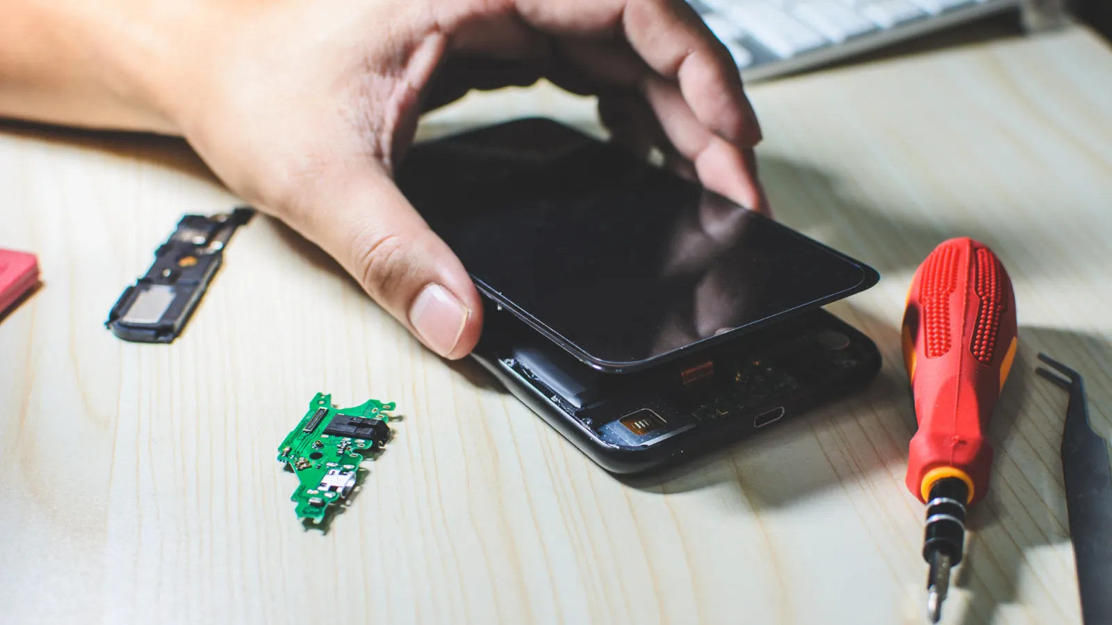 mobile phone with back open and screw driver