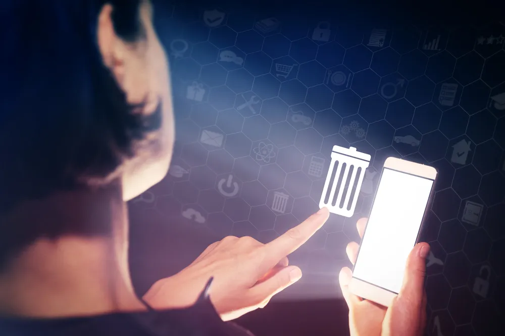 Person deleting items on a mobile phone