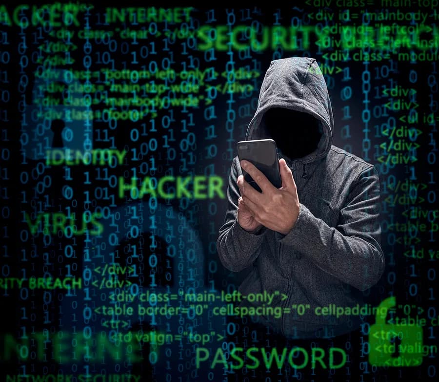 person wearing a sweatshirt with their hood up holding a mobile phone surrounded by coding phrases