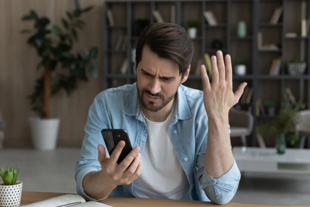 man confused by cell phone