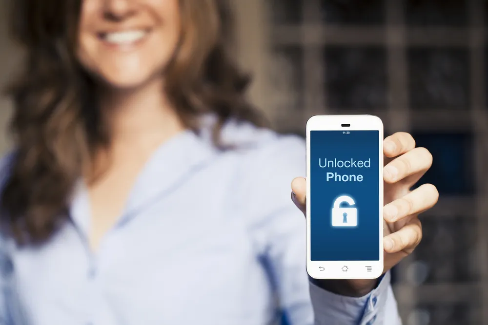 happy person holding unlocked iphone
