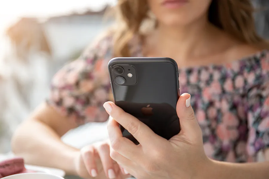Woman holding an iPhone 11