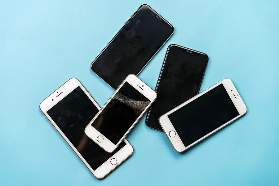 Old iphones on a blue background
