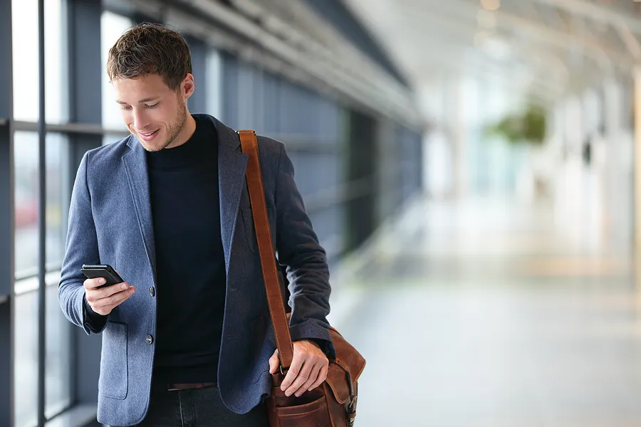Man walking with phone in his hand.