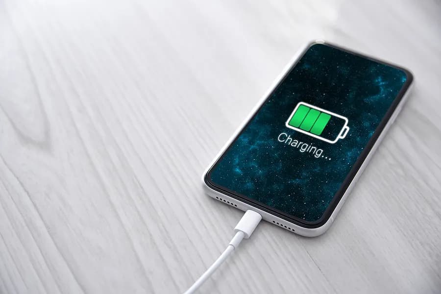 Mobile phone plugged into charger.